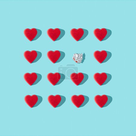 Photo for Trendy love composition made of Red heart chocolates on blue background. Minimal concept of Valentine's Day or love. Creative art, minimal aesthetics. Top view. Flat lay - Royalty Free Image