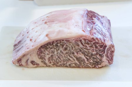 Japanese Wagyu beef with marbled fat, a delicacy in Japan. Wagyu beef has an increased fat percentage due to a decrease in grazing and an increase in using feed, resulting in larger, fattier cattle.