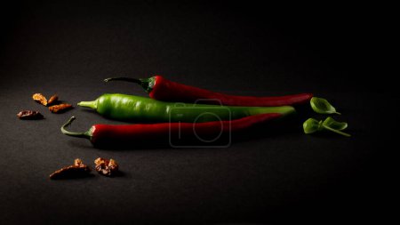 red green paprika chili on black background