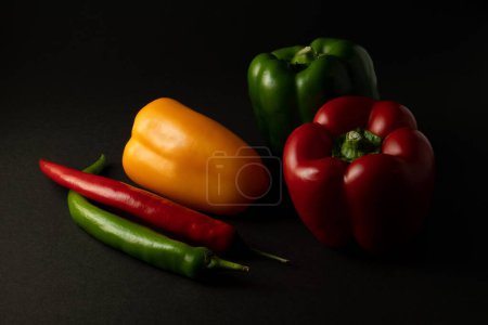 colorful vegetables paprika chili on black background