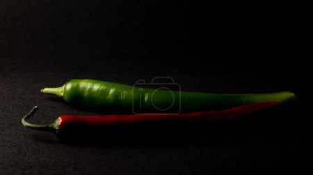 red green paprika chili on black background