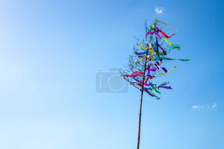May tree, traditional hungarian austrian german folklore colorful decoration with ribbons in may with blue sky