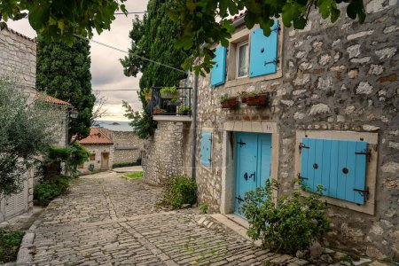 beautiful street of Rovinj Croatia with cobblestone and colorful shutters .