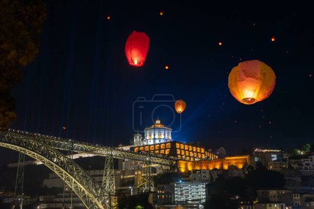 Festa de Sao Joao do Porto flying lanterns in Porto Portugal at st Johns eve next to douro river bank Ponte Luis and Miradouro da Serra do Pilar .