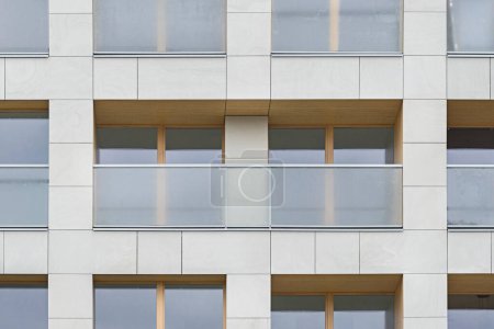 Photo for Detail for a multifamily building in the city center. Large number of floors. Balconies and loggias. Sunshine in the city - Royalty Free Image