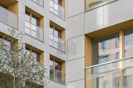 Detail for a multifamily building in the city center. Large number of floors. Balconies and loggias. Sunshine in the city