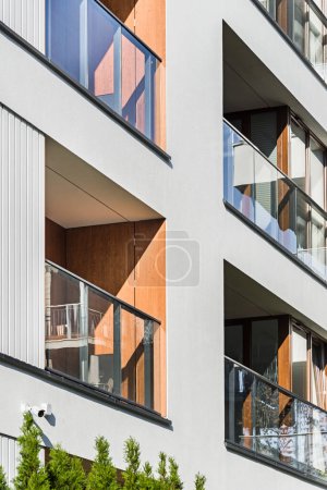 Photo for Detail for a multifamily building in the city center. Large number of floors. Balconies and loggias. A large amount of greenery around the building - Royalty Free Image