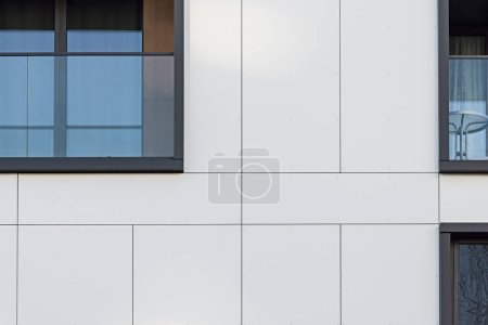 Photo for Detail for a modern multifamily building in the city center. Large number of floors. Balconies and loggias. Sunny weather - Royalty Free Image