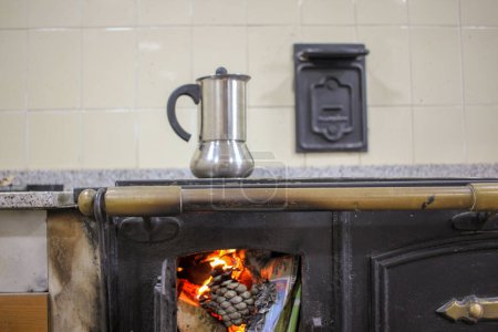 Photo for Rustic Aromas: Coffee Brewing on a Wood-Burning Stove - Royalty Free Image