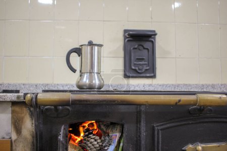 Photo for Wood-Fired Elixir: Brewing Coffee on a Cozy Stove - Royalty Free Image