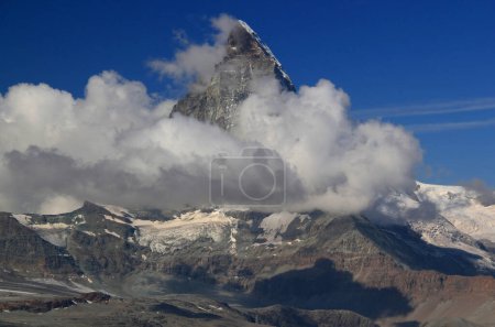 Photo for A landscape with a mountain Matterhorn view partially covered by clouds on a mountain Gornergrat, near Zermatt, in southern Switzerland - Royalty Free Image