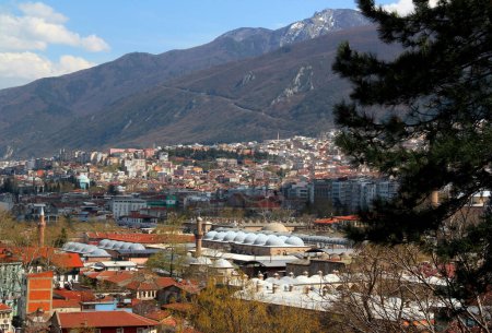 Photo for A panoramic view of the city of Bursa (Turkey) with many mosques, hans and Uludag mountain in the background against a blue sky with clouds - Royalty Free Image