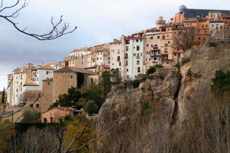 Photo for Cliffs and a row of colored houses against a stormy sky in the historic part of Cuenca, near Madrid, Spain - Royalty Free Image