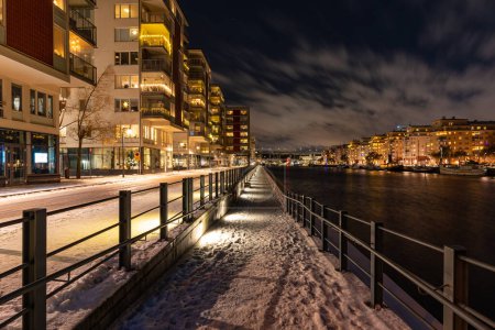 Photo for Stockholm, Sweden - December 18, 2022: night view of modern Stockholm living neighborhood Hammarby at winter - Royalty Free Image