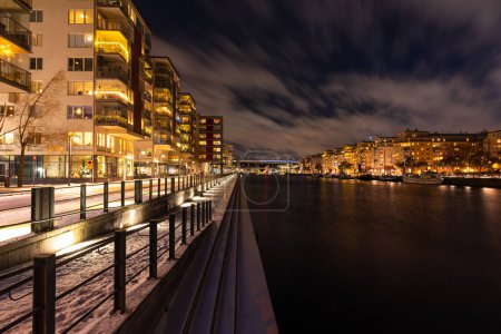Photo for Stockholm, Sweden - December 18, 2022: modern neighborhood Hammarby Sjstad  at night - Royalty Free Image