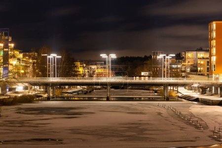 Photo for Stockholm, Sweden - December 18, 2022: Lugnets All bridge over Sickla canal  at winter night - Royalty Free Image