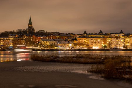 Photo for Stockholm, Sweden - December 18, 2022:  view of Hamnvakten as seen from Hammarby Sjstad at night - Royalty Free Image