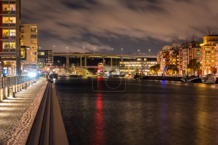 Photo for Stockholm, Sweden - December 18, 2022: Skansbron (Skans Bridge) and Skanstullsbron as seen from Hammarby kaj  at night - Royalty Free Image