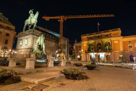 Photo for Stockholm, Sweden - December 23, 2022: Royal Swedish Opera entrance and Gustav II Adolf monument at night with renovations going on in background - Royalty Free Image