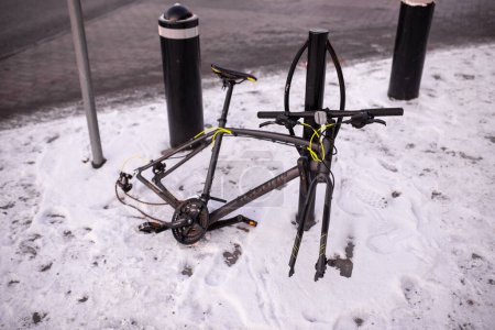 Photo for Stockholm, Sweden - January 07, 2023: Bicycle protection concept: disassembled bicycle on the street with parts stolen on winter day - Royalty Free Image