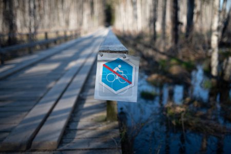 Photo for Bicycle restriction concept: sign that restricts biking on certain area in the woods (selective focus) - Royalty Free Image