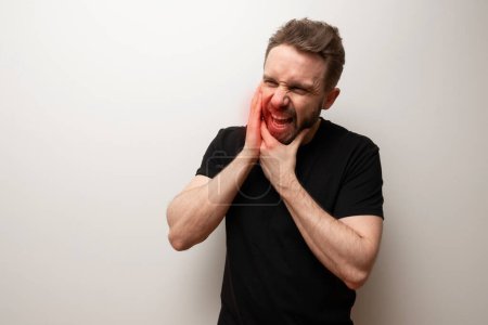 Photo for Jaw pain problem concept: bearded hipster middle aged man holds his lower jaw - Royalty Free Image