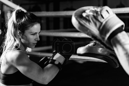 Photo for Woman on boxing training with personal trainer - Royalty Free Image