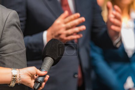 Photo for Journalists holding microphone, interviewing politician. - Royalty Free Image