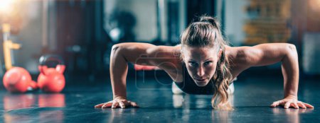 Photo for Woman Doing Push-ups in the gym. Strength Training. - Royalty Free Image