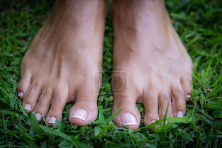 Photo for Earthing or grounding, woman without shoes standing on the ground, feeling the grounded. - Royalty Free Image
