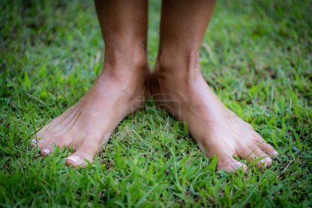 Téléchargez les photos : Mise à la terre ou mise à la terre, femme sans chaussures debout sur le sol, sentant la terre. - en image libre de droit