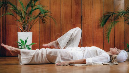 Photo for Woman practicing Kundalini Yoga, Kriya exercises for the navel center and bowel waste elimination - Royalty Free Image