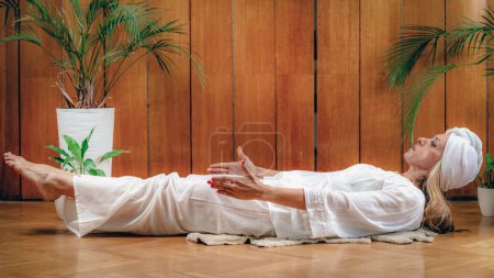 Photo for Woman practicing Kundalini Yoga, Kriya exercises for the navel center and bowel waste elimination - Royalty Free Image