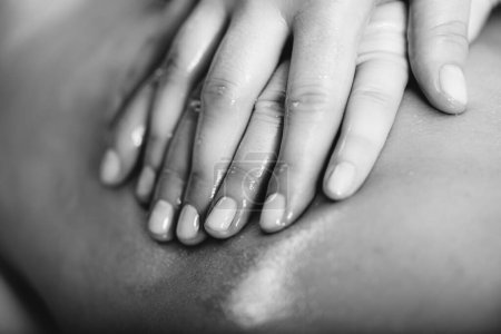 Photo for Relaxing legs massage, hands of a female massage therapist massaging female clients legs - Royalty Free Image