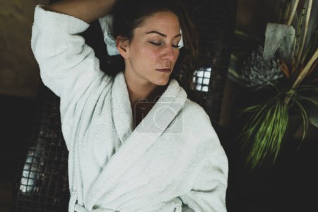 Photo for Woman in Bathrobe Lying on a Tepidarium Bed. - Royalty Free Image