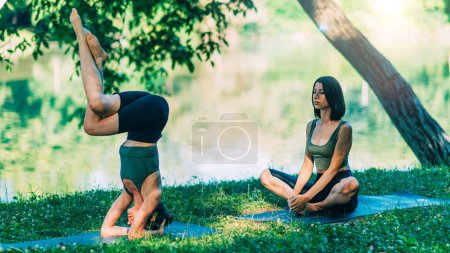 Photo for Yoga Woman by The Water. Headstand Pose - Royalty Free Image