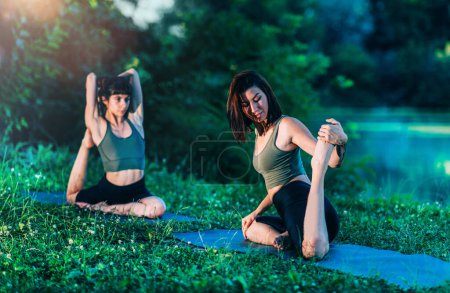 Photo for Yoga Women by The Water. King Pigeon - Royalty Free Image