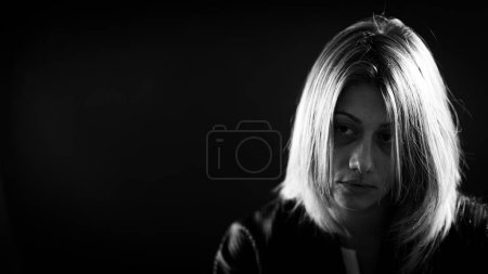 Téléchargez les photos : Melancholy  dramatic portrait of a hopeless woman looking away - en image libre de droit