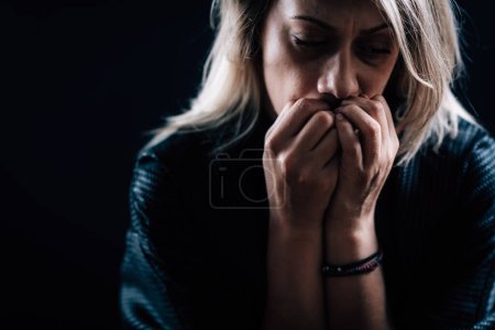 Photo for Anxiety disorder concept - portrait of anxious woman on a dark background - Royalty Free Image