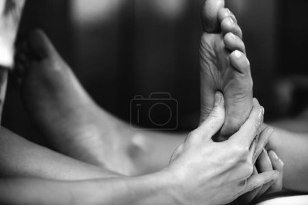 Photo for Ayurvedic Reflexology Foot Massage, Ayurveda practitioner pressing meridian points on female foot. - Royalty Free Image