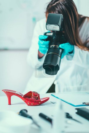 Photo for Forensic Science in Lab. Forensic Scientist photographing shoe with evidences - Royalty Free Image