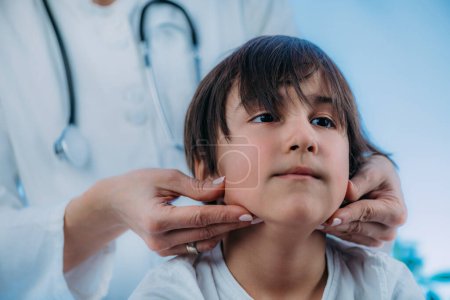 Pediatric Endocrinologist, medical doctor who specializes in the diagnosis and treatment of hormonal disorders, examining preschooler boy.