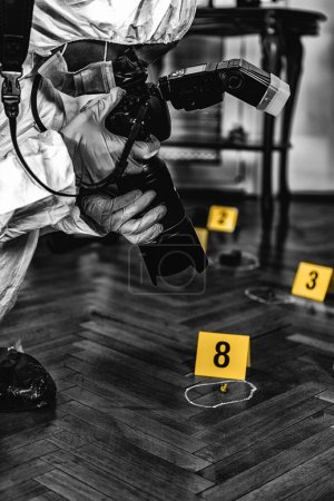 Photo for Police Forensic Detective Photographing Crime Scene, Collecting Evidence - Royalty Free Image