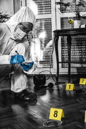 Photo for Forensic Investigator Collecting Crime Scene Evidence - Royalty Free Image