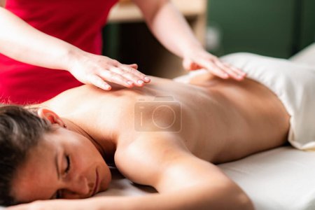 Photo for Massage for stress and tension relief. Female massage therapist massaging a woman - Royalty Free Image