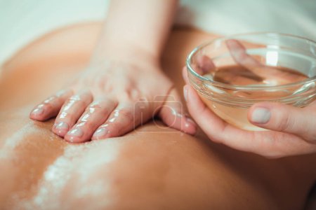Photo for Massaging with massage oil, hands of a female massage therapist massaging a female client - Royalty Free Image