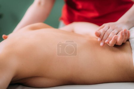 Photo for Back massage in a massage salon, woman having a relaxing back massage. - Royalty Free Image