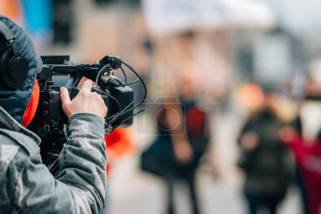 Photo for Television camera at the public protest, street demonstrations, blurred people in the background - Royalty Free Image