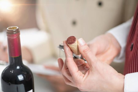Photo for Wine tasting sensory analysis and evaluation. Wine education trainees evaluate the aroma, taste, and finish of a red wine, learning to identify its key characteristics and flaws. - Royalty Free Image