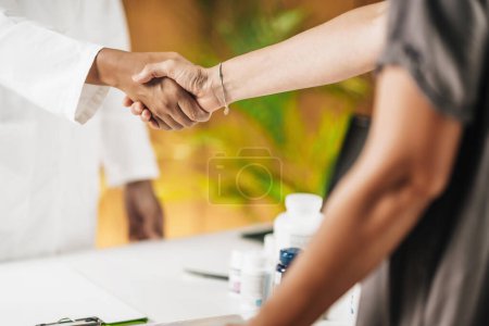 Photo for Functional medicine doctor shaking hands with patient - Royalty Free Image